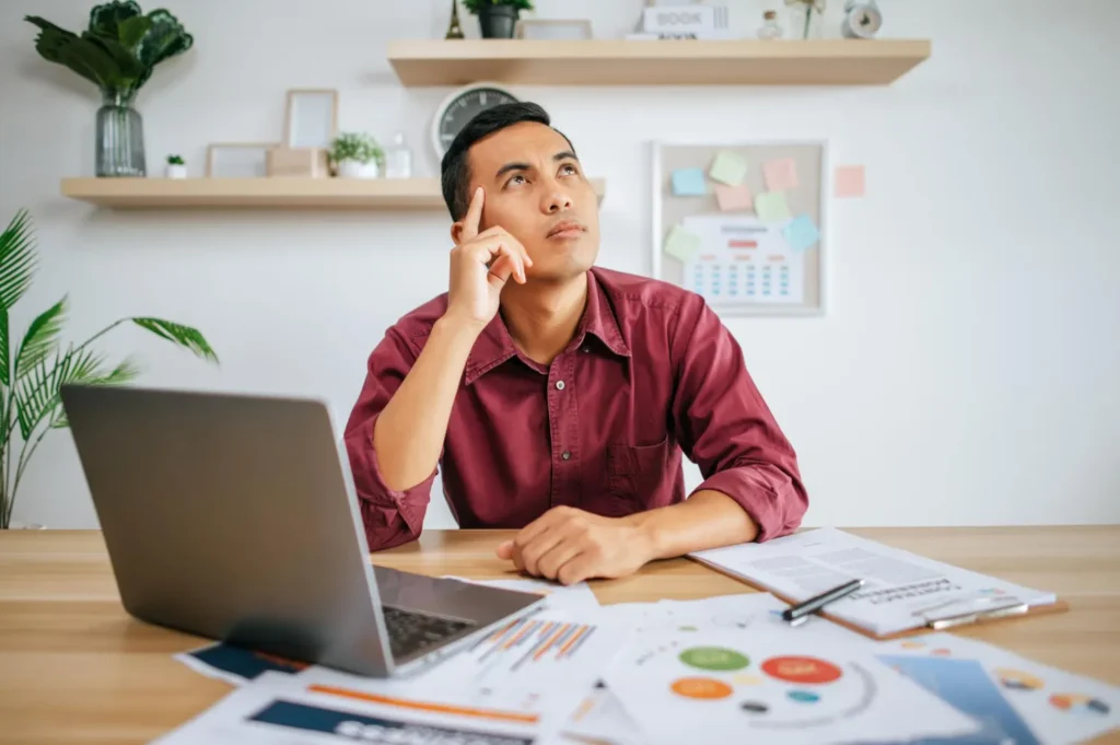 Professional conducting SEO audit analysis with laptop and marketing reports showing analytics data and performance metrics